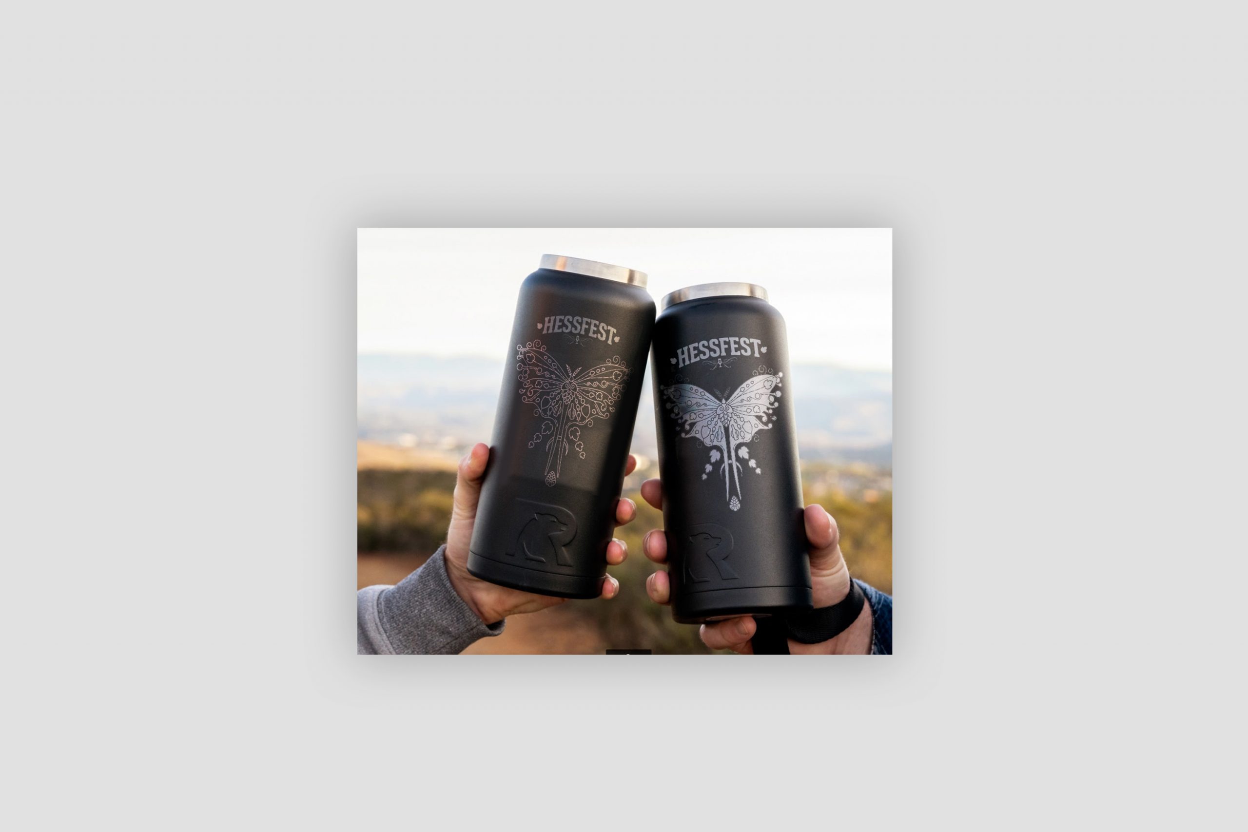 2 water bottles with a moth design on them