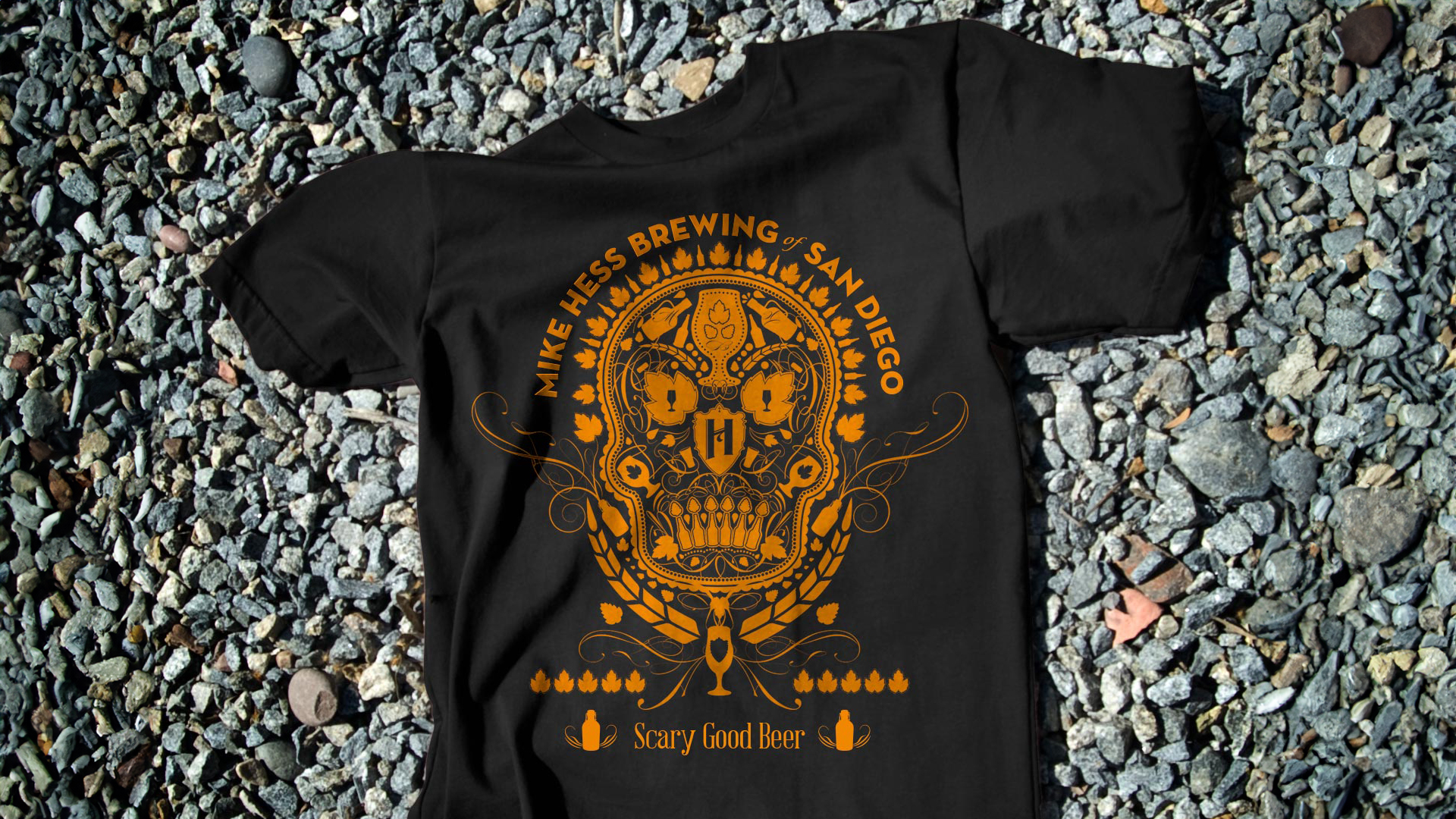 1920x1080-skull-shirt A black shirt sits on a background of gray rock. It has a graphic skull on it.