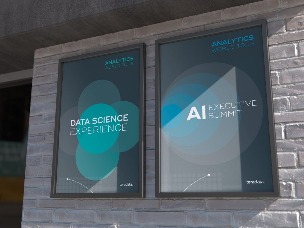 2 posters advertising a data conference, outside a brick building.